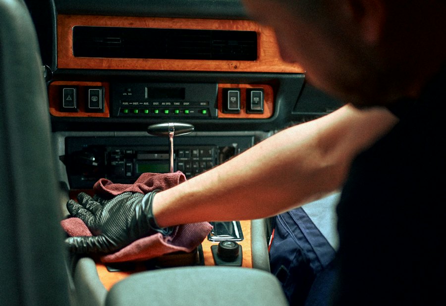 Gloved hand wiping a car's center console