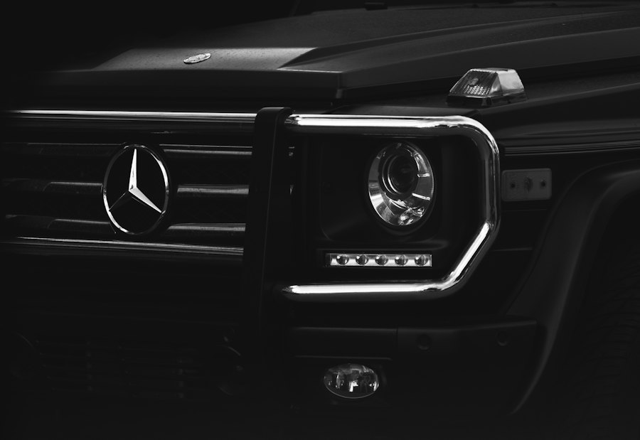 Front of a black Mercedes G-Class in low light